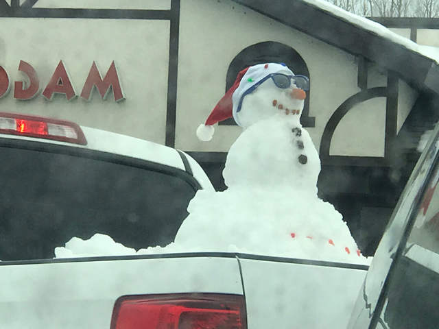 Snowman riding in truck